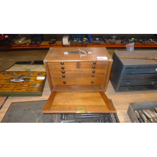 5081 - A wooden 7 drawer tool makers cabinet with removable front panel  containing various precision tools... 