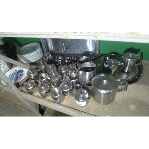 1063 - A quantity of various catering related stainless steel items including teapots, milk jugs, table num... 