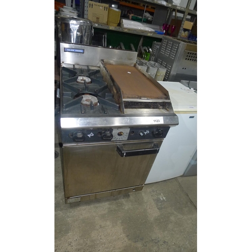 1123 - A 2 burner gas fired range by blue seal with griddle and oven beneath missing control knob - trade