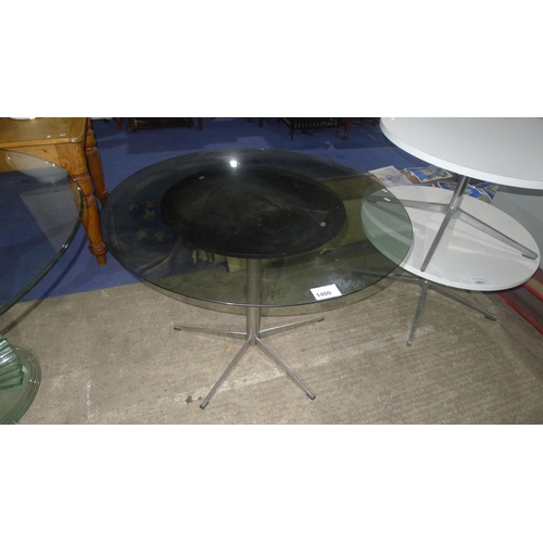 1400 - 1 circular table with a metal frame and a fixed black top diameter approx 59cm together with a circu... 