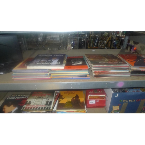 2094 - A quantity of various LP vinyl records, 45rpm singles, CDs etc. Contents of 2 shelves