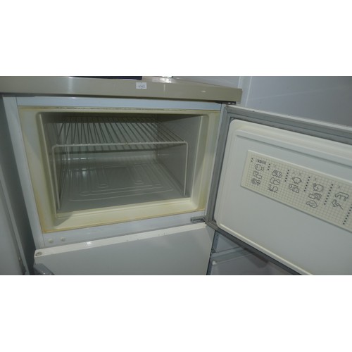 1114 - A 3/4 height fridge freezer by Zanussi - requires attention 240v trade