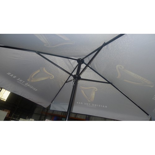 3140 - An unused 2m sq Guinness branded parasol with plastic base