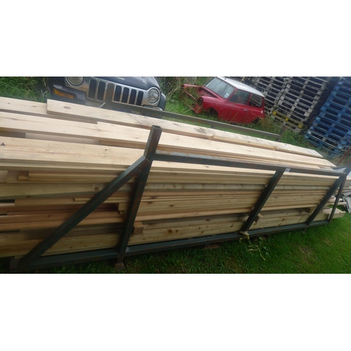 549 - A metal stillage containing a quantity of various lengths of wood including rails, tongue / groove, ... 