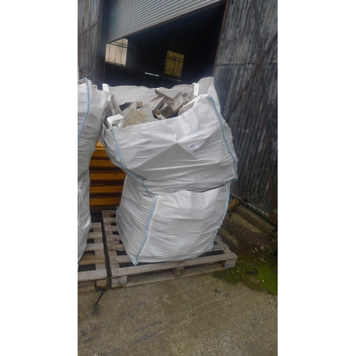 572 - A stack of two dumpy bags both containing wood offcuts