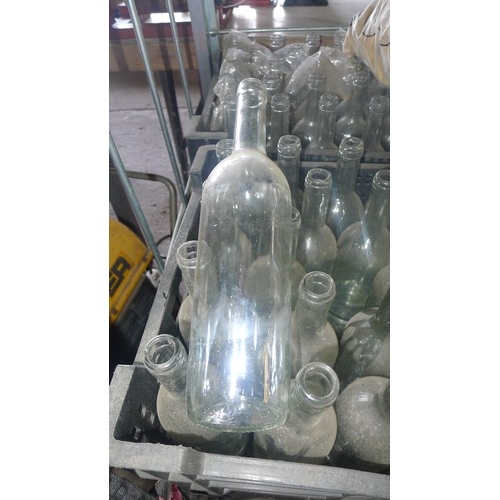 3134 - A quantity of clear glass wine bottles and corks. Contents of 1 wheeled cage which is not included