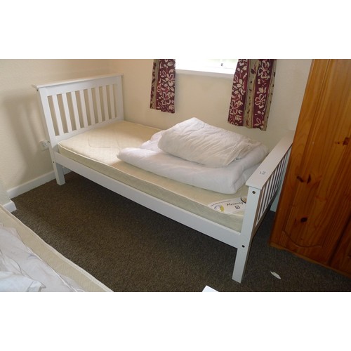 56E - 2 white painted single beds, a pine chest of drawers, a pine mirror and a pine wardrobe - Situated i... 