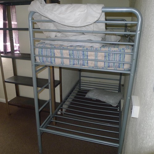 87 - The contents of student dormitory comprising of 8 bunk beds and 4 bays of Dexion type racking - Situ... 