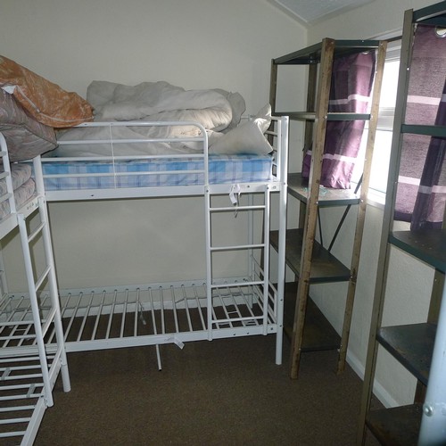 87 - The contents of student dormitory comprising of 8 bunk beds and 4 bays of Dexion type racking - Situ... 