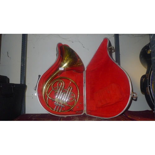 3018 - A brass French horn with carry case, maker not visible