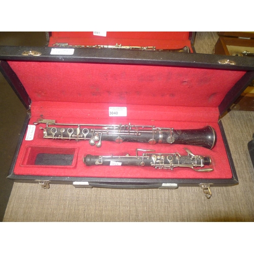 3040 - An oboe with carry case by Corton and Selmer