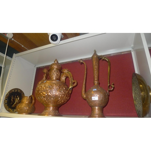 3114 - Two large Eastern style embossed copper pitchers, a small similar copper jug and two decorative bras... 