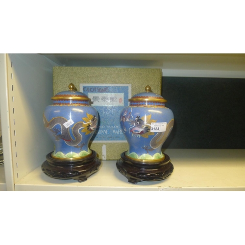 3123 - A pair of blue ground dragon decorated Chinese cloisonne jars with covers and stands