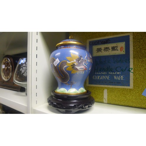 3123 - A pair of blue ground dragon decorated Chinese cloisonne jars with covers and stands