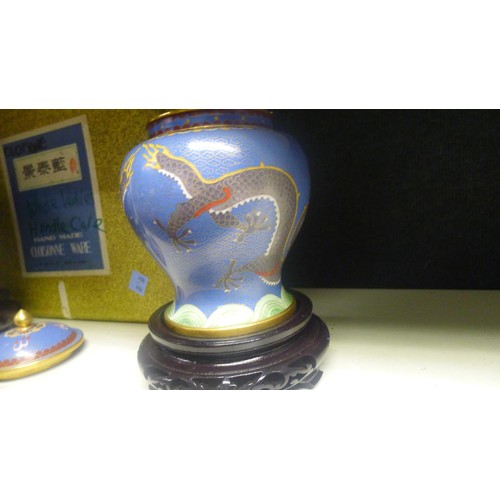 3123 - A pair of blue ground dragon decorated Chinese cloisonne jars with covers and stands