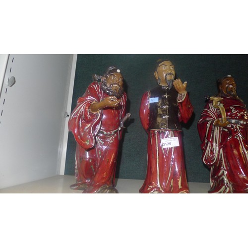 3126 - A set of 5 heavy pottery oriental figures of red robed gentleman