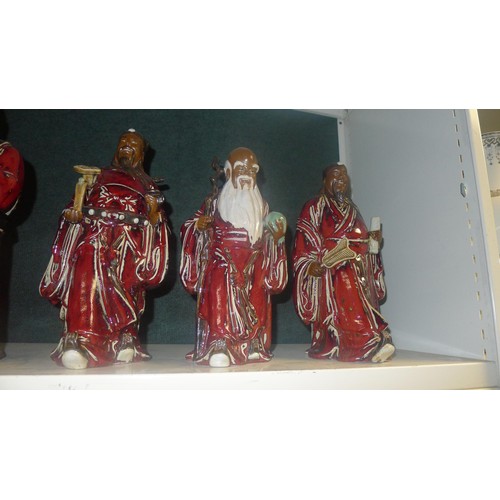 3126 - A set of 5 heavy pottery oriental figures of red robed gentleman