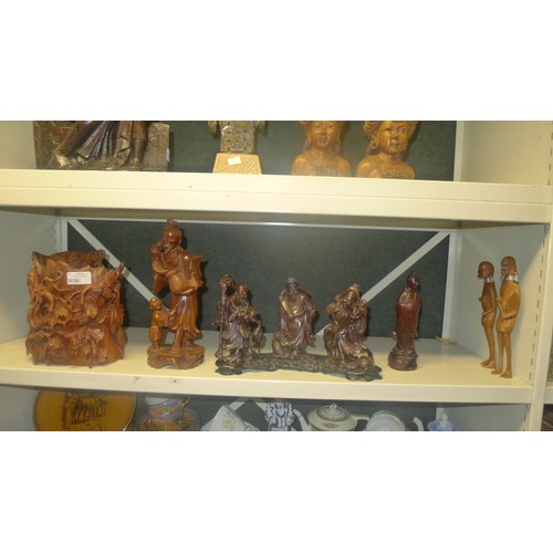 3138 - A quantity of miscellaneous oriental carved hardwood figures (2 shelves)