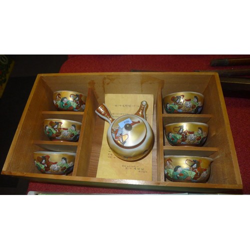 3244 - A boxed set of decorative Japanese tea bowls with teapot