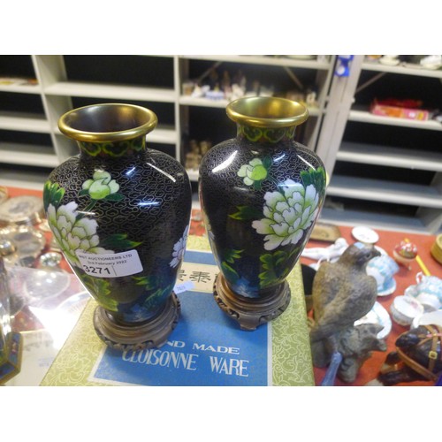 3271 - A pair of black ground floral decorated cloisonne vases with stands and box