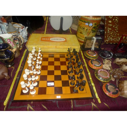 3315 - A carved bamboo Oriental style chess set with chess board