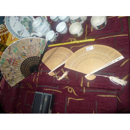 3323 - A decorative Japanese fan and 2 decorative wooden fans