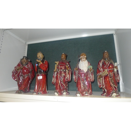 3126 - A set of 5 heavy pottery oriental figures of red robed gentleman