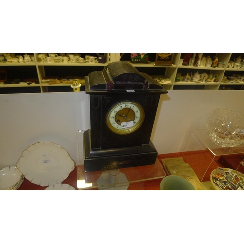 3251 - An Edwardian black marble cased mantel clock with a circular dial