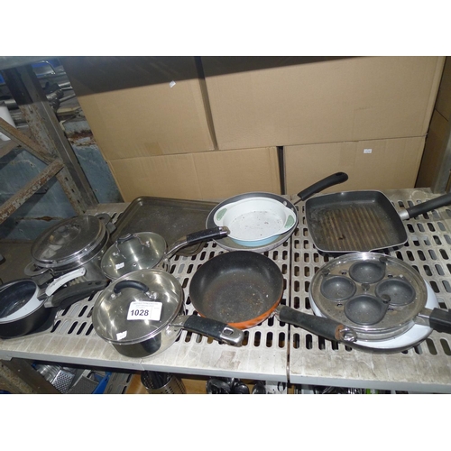 1028 - A quantity of various pots, pans, baking trays etc. Contents of one shelf
