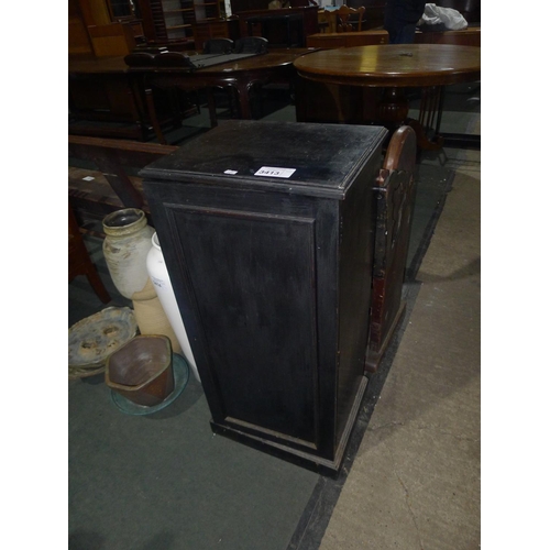 3413 - A floor standing ebonised music cabinet with a panelled door enclosing shelves