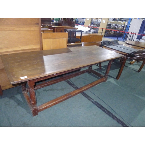 3428 - An antique Oak refectory table with turned legs and stretchers, approximately 234 cm long