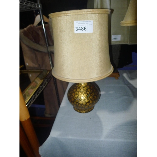 3486 - A black and gold coloured papier mache table lamp with shade