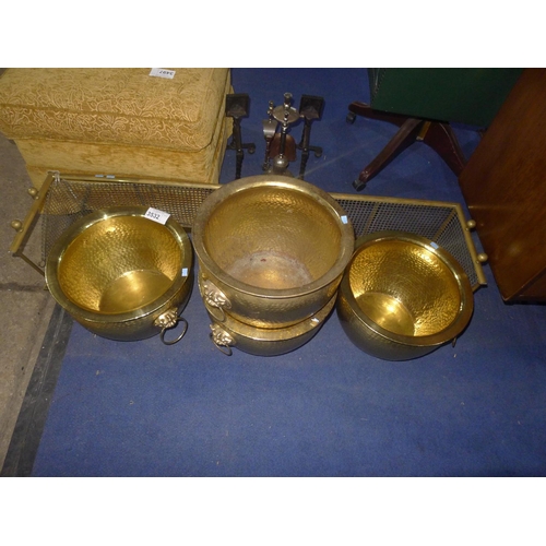 3532 - A brass rail fire fender and four decorative brass log bins