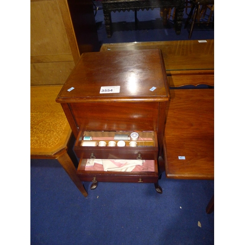 3554 - A Mahogany sewing box with a lift lid and two drawers under with contents