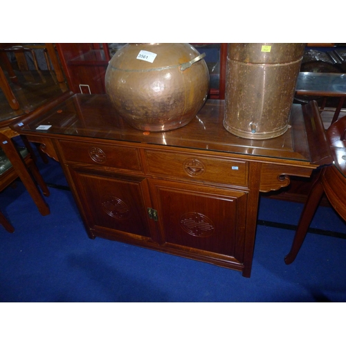 3560 - An Oriental hardwood sideboard with two drawers and two doors under, approximately 136 cm wide