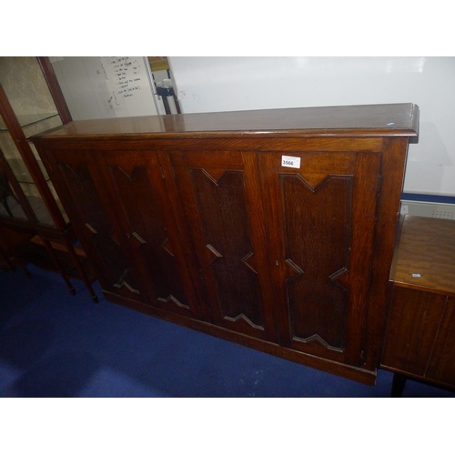 3566 - A dark oak floor standing cabinet with 4 panelled doors, approx 186 cm wide