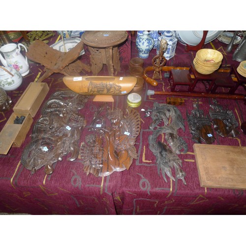 3328 - A large quantity of miscellaneous decorative carved wooden wall plaques, wooden stands and other woo... 