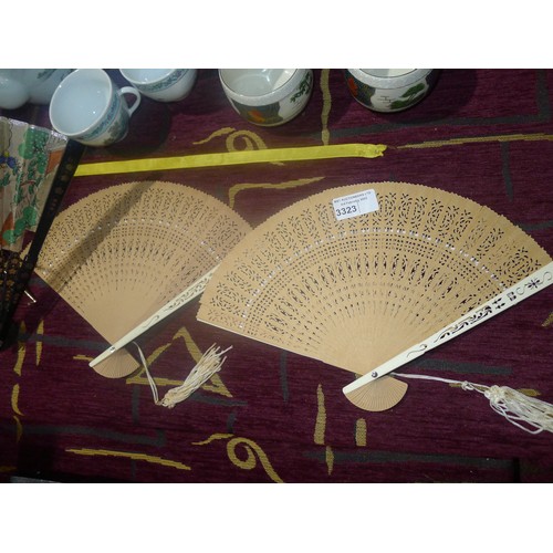 3323 - A decorative Japanese fan and 2 decorative wooden fans