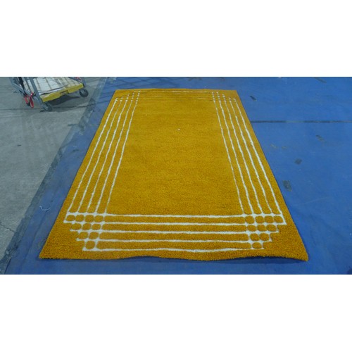 3496 - An orange pattern shagpile carpet approximately 270 cm x 180 cm