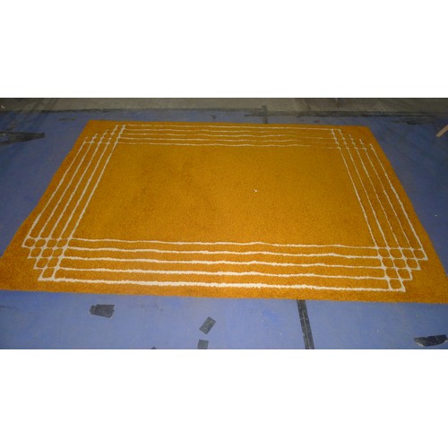 3496 - An orange pattern shagpile carpet approximately 270 cm x 180 cm