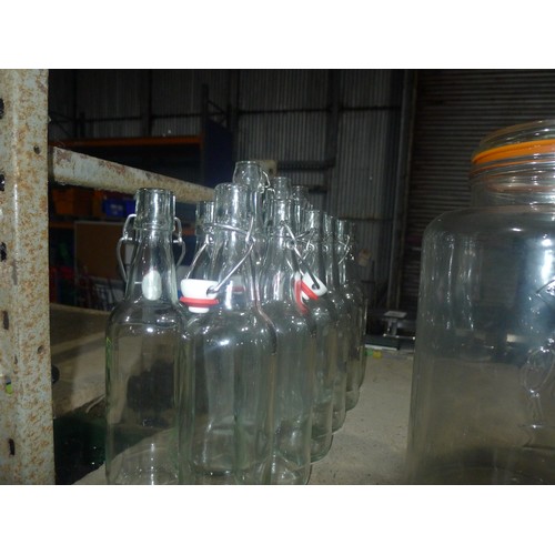 1030 - A quantity of various glass drink dispensers, jugs and bottles, contents of one shelf