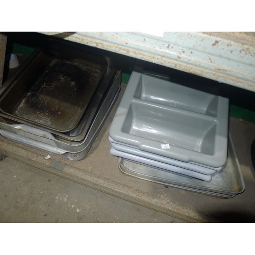 1039 - A quantity of various baking trays, serving trays, cutlery trays etc. Contents of one shelf