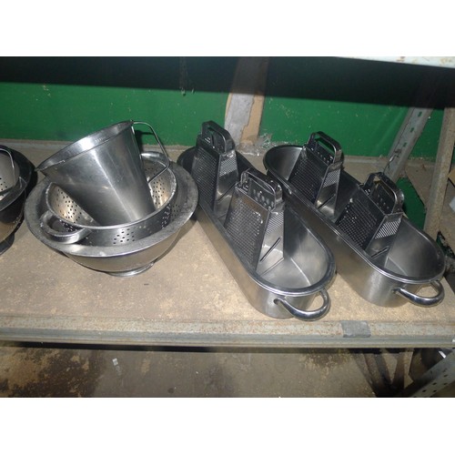 1046 - A quantity of various catering related stainless steel items including colanders, sieves, graters et... 