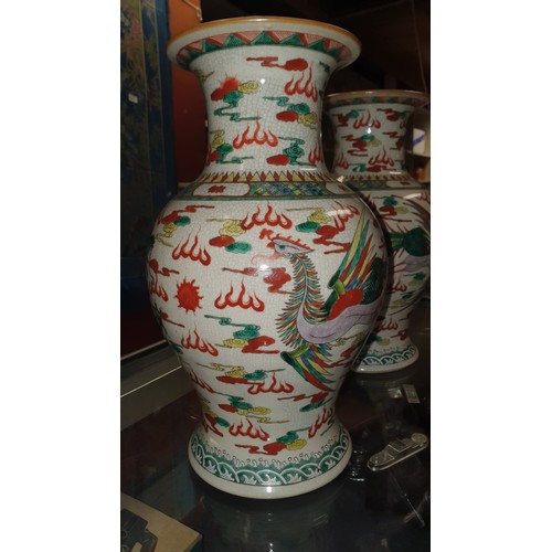 3178 - A pair of multi-coloured Chinese bird and floral decorated bulbous vases, good condition.