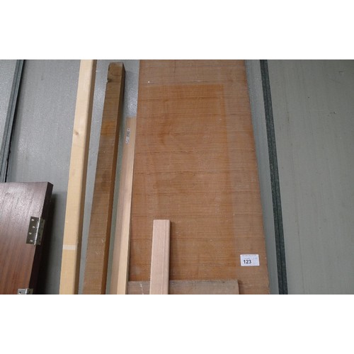 123 - A quantity of various lengths of wood including a sawn board at approx 305cm long x 48cm wide x 3cm ... 