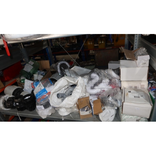 1215 - A quantity of various plumbing related items including wastes, bowl plumbing kits, bottle traps, pla... 