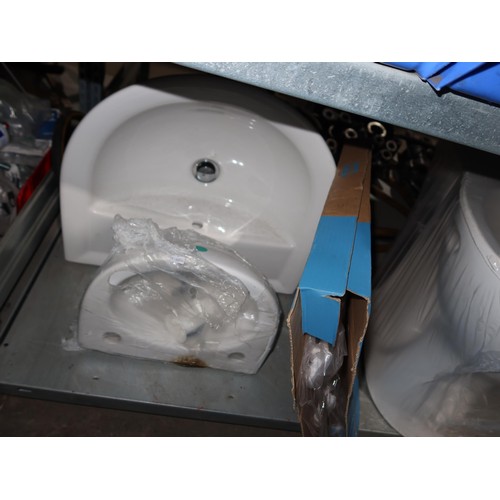 1219 - A white ceramic toilet pan, a cistern with lid, a toilet seat, a large hand basin and a small hand b... 