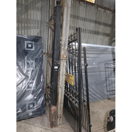 1089 - A pair of black painted ornate metal gates and two metal concrete in gate posts, each gate is approx... 