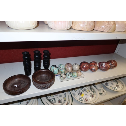 3170 - A collection of tribal decorated heavy egg shaped stones & small carved hardwood ornaments