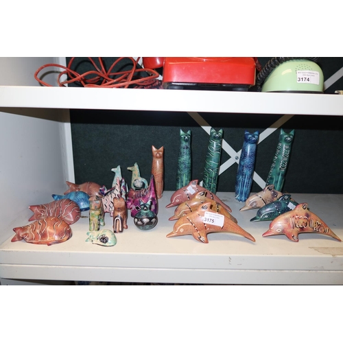 3175 - 6 decorative multi-coloured Soapstone dolphins & a collection of Soapstone cats (one shelf)